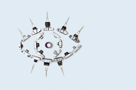 Unusual image of eye, assembled from retro cameras on a gray backgroundの写真素材