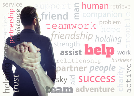 Concept, depicting help. Image created using multiple exposures and adding meaningful words. Image silhouette of a man in a  business suit and a handshake.の写真素材