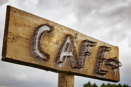 Cafe sign on a wood board, along  road.の写真素材