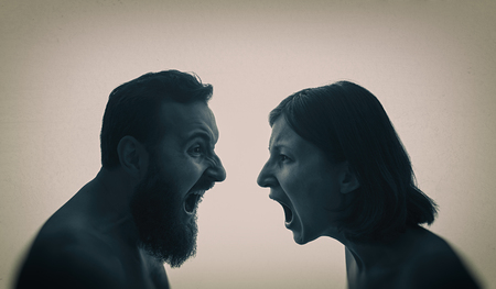 A man and a woman scream at each other. The concept of a family quarrel, violence, misunderstanding.の写真素材