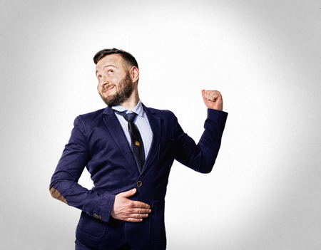The concept of success. Portrait of a funny bearded man with a smile on his face.の写真素材