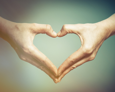 Two hands in the shape of a heart. The concept of love, harmony, caring.の写真素材