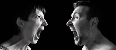 Man and woman yell at each other on black isolated background.