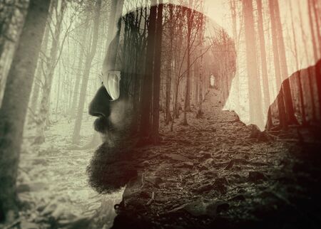 Double exposure with bearded traveler and dense forest. Metaphor of travel and camping.