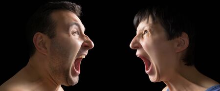 Man and woman yell at each other on black background.の写真素材