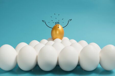 Business recruitment, talent management. One golden egg with crown in top of white eggs group on...
