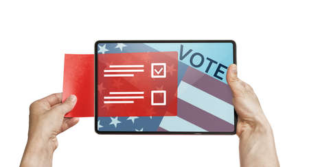 The human holds a digital tablet with paper ballot. Concept of e-voting via digital tablet.の写真素材