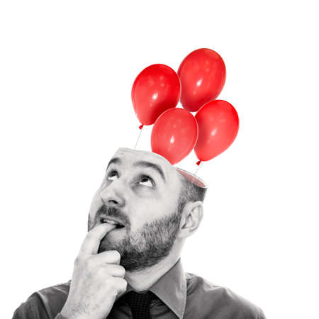 Red balloons fly out of the man's head. The concept of a new idea. Black and white.の写真素材