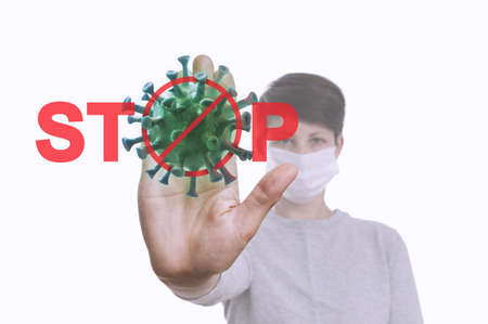 Stop the coronavirus! Red sign STOP with coronavirus model and woman's palm of hand. Concept.