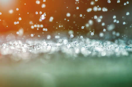 Raindrops splashes on sunset. Close-up.の写真素材