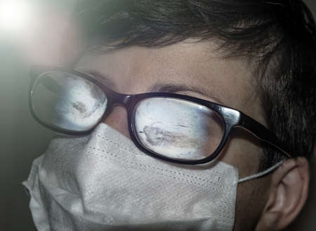 Fogged glasses. Discomfort experienced in wearing a face mask.の写真素材