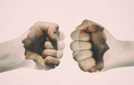 Multiple exposure with man and woman silhouette and clash of their fists. Concept of confronting.