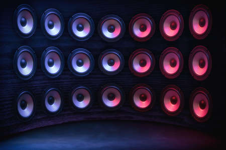 Group of sound speakers in neon light on black.の写真素材