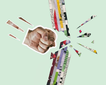 A fist with a human face breaks through the wall. Art collage. Concept of rage, recklessness.の写真素材