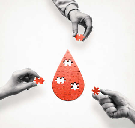 A puzzle in the form of a drop of blood. Blood donation. Concept. International Blood Donor Day.