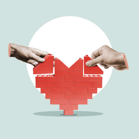 Two people are building a heart from a constructor.の写真素材