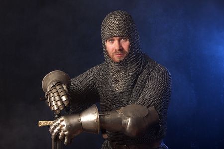 The soldier in a medieval knightly armour with we throw in handsの写真素材