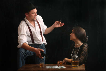 The man-gangster and the beautiful girl talk in a barの写真素材