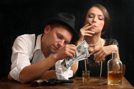 The man-gangster and the beautiful girl talk in a barの写真素材