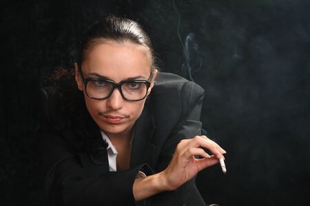 The woman in an image of the man, the transvestite with a cigaretの写真素材