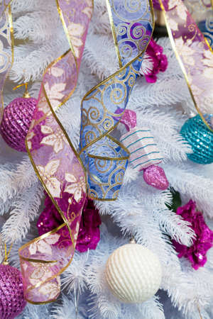 the white New Year tree decorated with tapes and toysの写真素材