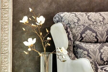 vase with the flowers near a magnificent sofaの写真素材