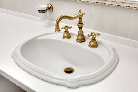 beautiful modern sink with the copper mixer in a bathroomの写真素材