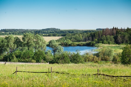 Picturesque water smooth surface of a pond in the village about the woodの写真素材