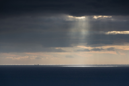 Bright sunlight over ocean, beautiful shine sun beam in sky, abstract blue natural background, peaceful skyscape, open heaven and God, morning sun rays, Mediterranean resort, panoramic seaの写真素材