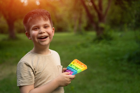 Pretty Boy Got for a Gift and Enjoying the Toy in his walking Time. Summer Weekend in the Country. Travelling with Kid. High quality photoの写真素材