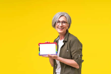 LGBTQ support mother. Confident mature woman holding digital tablet with white empty screen in LGBTQ...