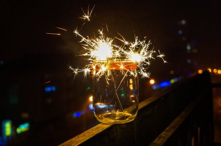 Festive Christmas fireworks at night on a street balcony
