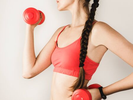 Stylish woman during exercises with dumbbellsの写真素材