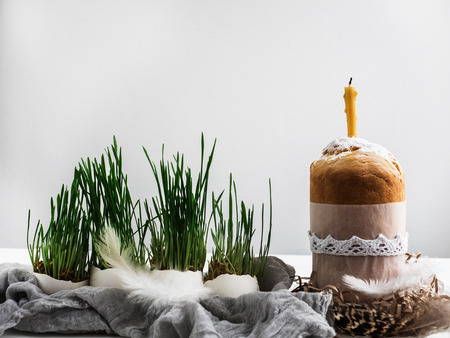 Fragrant cupcake on a background of fresh, green grass in pots. Preparing for Easterの写真素材
