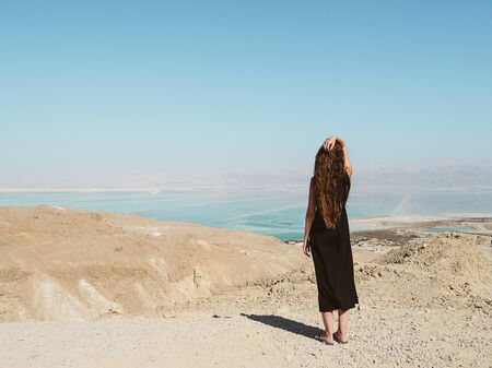 Young woman standing on a mountainの写真素材