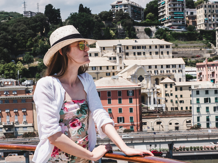 Woman standing on the deck of a cruise shipの写真素材
