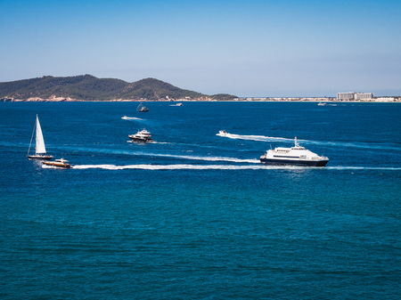 Seascape. Ship on the background of a coastline and a clear blue skyの写真素材