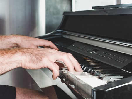 Mens hands and piano. Concept of classical musicの写真素材