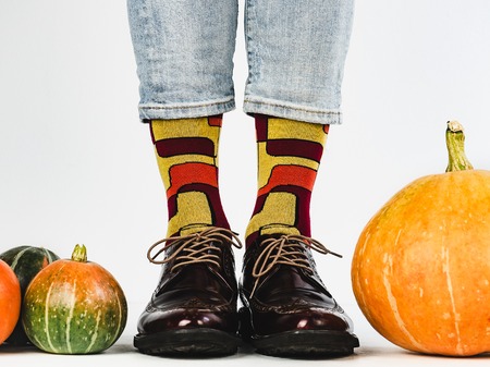 Beautiful pumpkins and mens legs in stylish shoesの写真素材