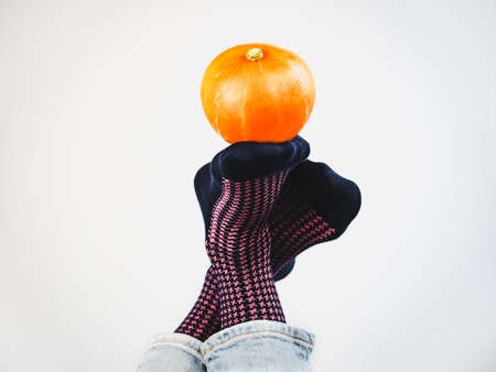 Ripe pumpkin, mens legs and funny socksの写真素材
