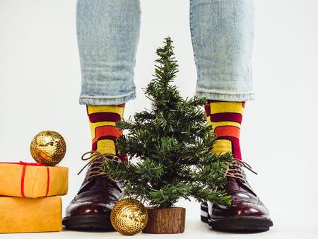 Mens legs, funny socks and a Christmas treeの写真素材