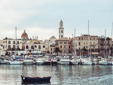 Sea bay and fishing boats on the background of beautiful, old housesの写真素材