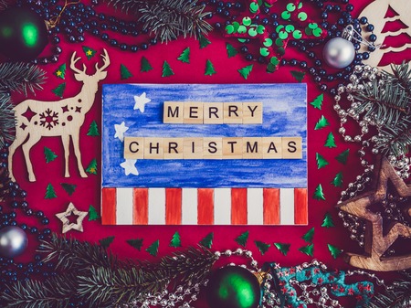 Colorful Christmas decoration, silver beads, Christmas tree branches, drawing and inscription in...