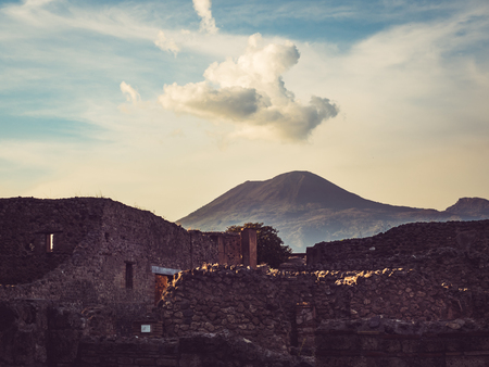 Beautiful view of the ancient city of Pompeii on the background of the volcano Vesuvius. Sunset photo. Concept of leisure and travelの写真素材