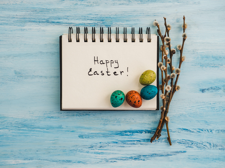 Easter eggs painted in bright colors on a blue background. Top view, close-up, isolated. Happy Easter. Preparation for the holidayの写真素材