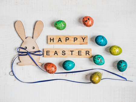 Wooden letters of the alphabet in the form of the words HAPPY EASTER on a white, isolated background. Top view, close-up. Congratulations for loved ones, relatives, friends and colleaguesの写真素材