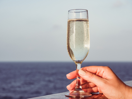 Cute woman holding a beautiful glass of champagneの写真素材