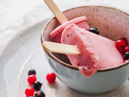 Pink fruit ice cream on a vintage plate. Close-up, top view. Concept of tasty and healthy food