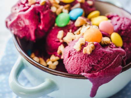 Bright, fruit ice cream on a vintage plate. White, isolated background. Close-up, top view. Concept of tasty and healthy foodの写真素材