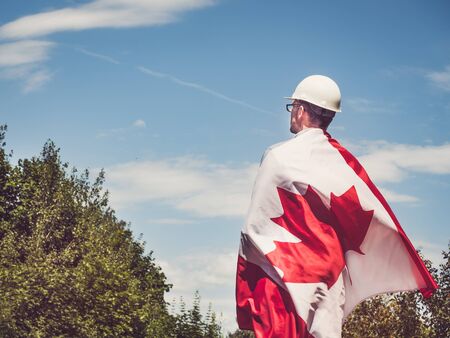 Engineer, holding Canadian Flag in the parkの写真素材